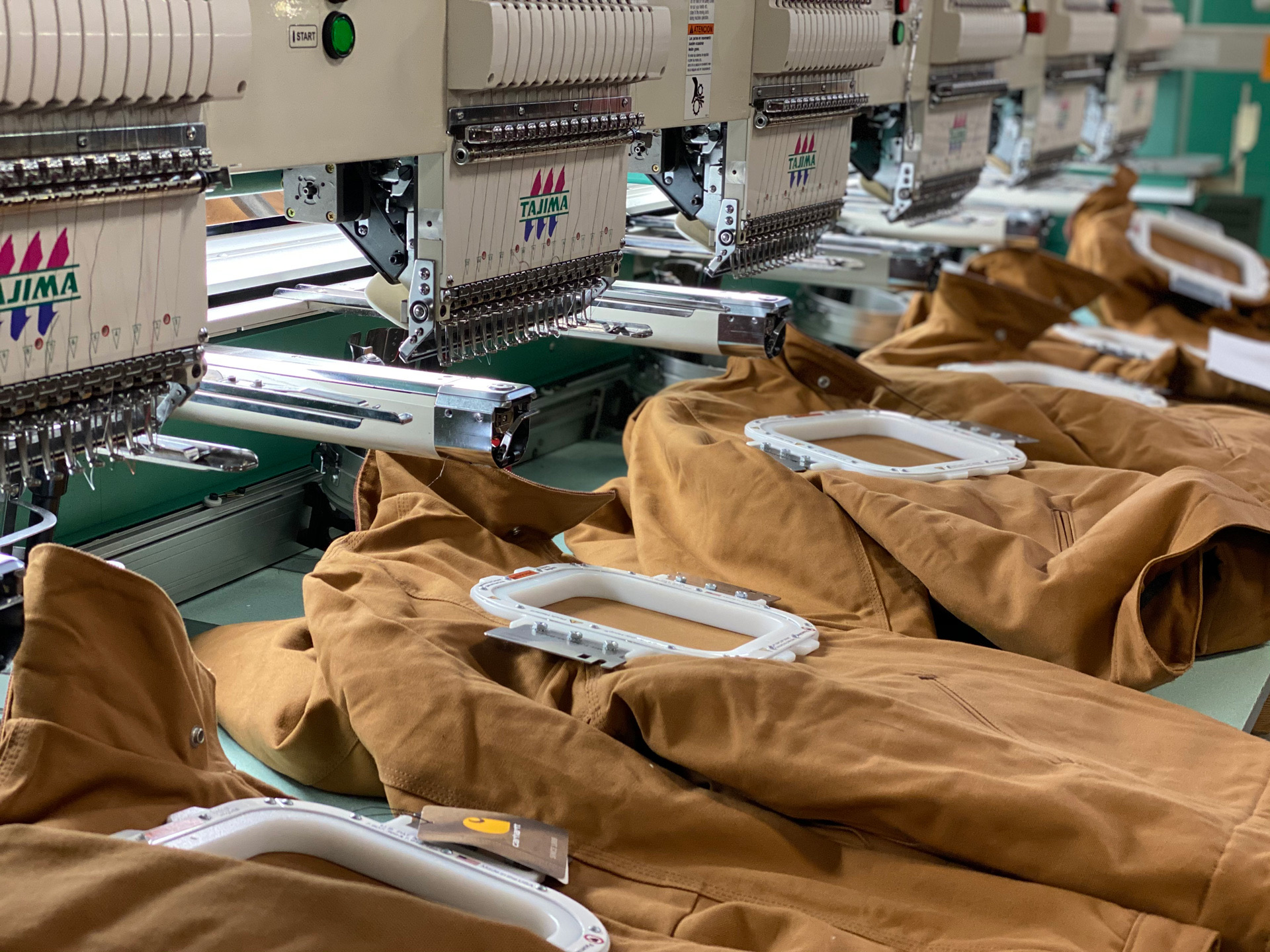 Close-up of the magnetic hoop hardware used to embroider Carhartt jackets